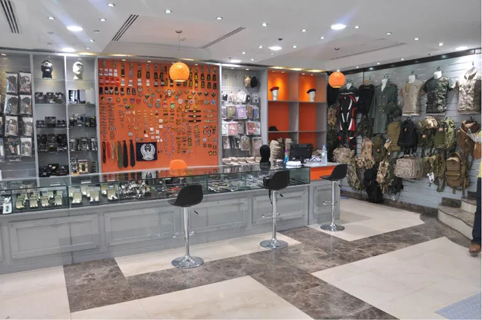 Showroom with orange display walls of boots and a central counter