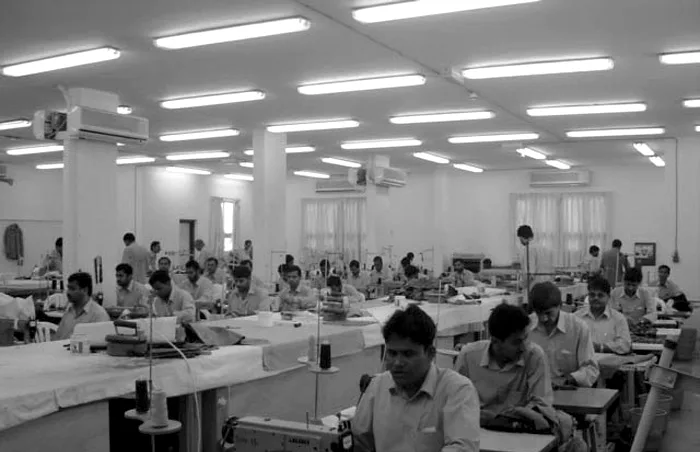 Machinists at sewing tables in the TSC workshop