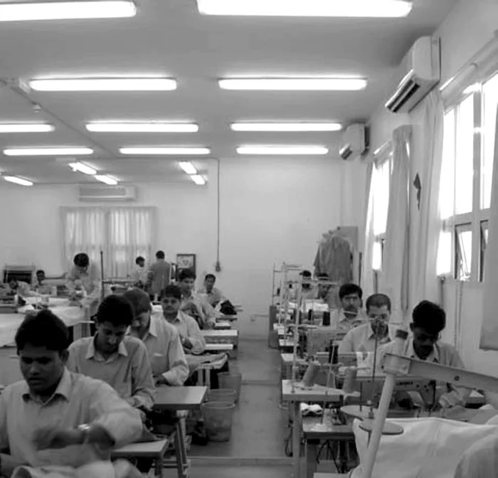 Machinists at sewing machines on the TSC workshop floor
