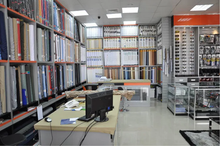Shelves of rolled fabric bolts in a TSC showroom
